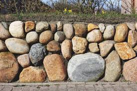 This is the stage where you have to dig along the base of the entire stone retaining work and ensure that the excavated holes do not go beyond 6 inches. How To Build A Dry Freestanding Stone Wall The Right Way