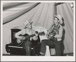 Singing cowboy songs at entertainment at the FSA (Farm Security  Administration) mobile camp for migratory farm workers. Odell, Oregon
