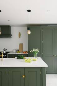 This Seaside Home Was Bright And Welcoming And The Dark Olive Paint Colour Was Such A Clever Choice Dark Green Kitchen Green Kitchen Cabinets Kitchen Trends