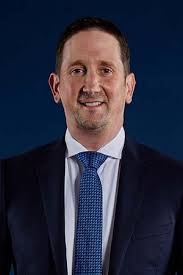 Georgia Southern men's basketball head coach Brian Burg reaches goal