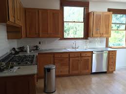 Backsplash With Maple Cabinets In 2020 Kitchen Tiles Design Unfinished Kitchen Cabinets Classic White Kitchen