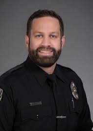 Officer Mark Postma On October 5, 2017 Officer Mark Postma was working  patrol when a caller contacted dispatch to report a man had fallen down in  the area of the track off