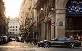 Black Coupe Car City Road Street Aston Martin Aston Martin Vanquish Building 1080p Wallpaper Hdw Aston Martin Virage Aston Martin Vanquish Aston Martin