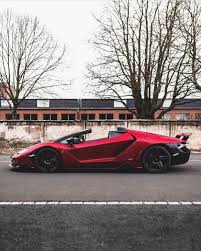 Black And Blue Lamborghini Centenario Lamborghini Centenario Roadster Painted In Rosso Efesto W A Black Central Stripe And Exposed Carbon Fiber Photo Taken By E Luxury Cars Cars Lamborghini Cars