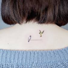 Tiny Birds On A Wire Tattoo Birds On A Wire Tattoo On The Upper Back Neck Tattoo Wrist Tattoos For Guys Tiny Bird Tattoos