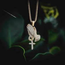 Embrace your faith with this beautiful 14k yellow gold pendant. Iced Praying Hands Pendant The Gld Shop