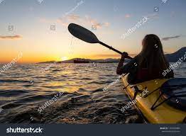 Woman On A Kayak Is Paddeling In The Ocean During A Vibrant Sunset Taken In Vancouver British Columbia Canada Concept Adventur Kayaking Stock Photos Ocean
