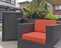 Shop patio furniture at amazon. Bright Orange Sunbrella Cushions Shine In This Courtyard Custom Chair Cushion Luxury Apartments Cushions