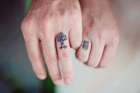 If you prefer a more intimate approach to a wedding ring tattoo, this heart design, which is only complete when the two partners' fingers are intersected, may be the right choice for you. Wedding Band Tattoo Ideas For Him Beloved Blog
