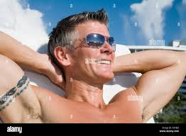 Man sunbathing and smiling Stock Photo