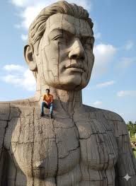 Prompt: Transform the person from the attached photo into a scene where he  is sitting