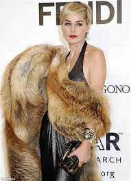 Tan belted trench coat with detachable faux fur collar. Sharon Stone Fur Coat Drone Fest