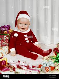 1960s Happy Baby Wearing Santa Claus Footed Pajamas Sitting Among Wrapped Christmas Presents Kx3618 Har001 Hars Home Life Copy Space Full Length Pajamas Indoors Nostalgia Happiness Cheerful Santa Claus Smiles December Joyful