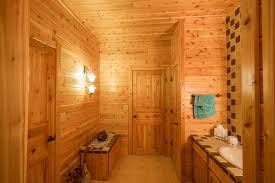 Floating counter top and a wooden bench that may dark wood bathroom cabinet with drawers on a contrasting navy wall. Add A Classic Touch To Cabins With Cedar Wood Paneling