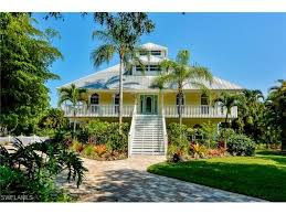Wifi, pool, view, kitchen, garden, bbq, hot tub Barefoot Beach 203 San Mateo Dr Bonita Springs Fl Yellow Old Florida Style Beach House With Sec Beach House Decor Cottage Exteriors Beach House On Stilts