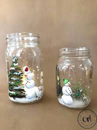 This Is A Winter Themed Hand Painted Mason Jar Featuring A Snow Family Decorating A Christmas Tree Th Painted Mason Jars Mason Jar Candle Holders Xmas Crafts
