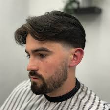 Blowout taper fade. Middle parting, keeping lots of weight