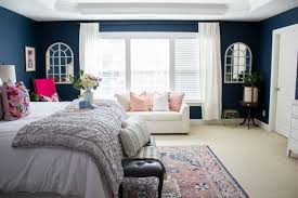 Yuni Min S Modern Master Bedroom Features Rich Navy Walls Hot Pink Accents And A Flatwoven Rug From Hot Pink Bedrooms Modern Master Bedroom Spring Home Decor