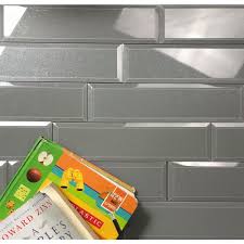 A kitchen with an interesting glass tile backsplash that looks different depending on the angle of the light. Abolos Frosted Elegance Glossy Gray 3 X 12 Beveled Glass Subway Backsplash Tile Tiles Building Materials Rbafamilylaw Com