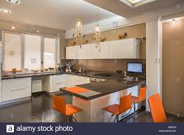 orange chairs in domestic kitchen stock