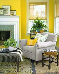Living room paint colors, pale yellow walls and curtains, light grey sofa and two cream colored chairs with pillows, big wooden chest used as table, white tray brighten your living room by working yellow into the palette. Yellow Living Room Yellow Room Yellow Walls Living Room