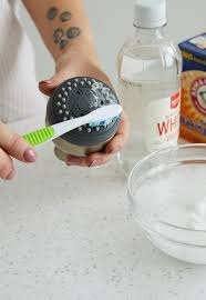 If you don't mind removing the head from the shower pipe, you can submerge the shower head in a container full of white vinegar. How To Clean A Showerhead Using Basic Pantry Ingredients Better Homes Gardens