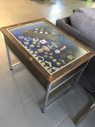 A simple yet sturdy design in modern smoked oak with gunmetal hardware gives this coffee table timeless appeal. Window Coffee Table Military Gift Military Retirement Military Shadow Box Shadow Box Military Shadow Box Shadow Box Coffee Table Military Coin Display