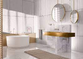 The bathtub of volcanic limestone and resin is by victoria + albert, and a ladder shelf keeps towels at a hand's reach. 10 Soothing Bath Products From Ish 2017 Bathroom Trends Modern Bathroom Trends Bathroom Trends 2019 2020