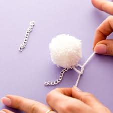 Use the thread to attach one end of a piece of chain. Diy These Trendy Pom Pom Earrings For Your Bff Brit Co