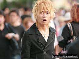 Ganguro appeared as a new fashion style in japan in the early 1990s and was prevalent mostly among young women. Japanese Guy With Blond Hair And A Black Coat Looking Quite Surprised Japanese Men Blonde Hair Black Coat