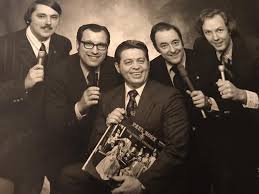 Early WUOK staff members appearing L-R are Gary Kirtley, Pat Corrado, Ed  Enderle, James “Doc” Webster and Steve Vandenberg. WUOK would later become  WCBC radio.