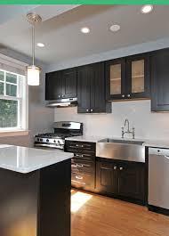 Remodeled Kitchen Features Stainless Appliances And Farmhouse Sink Along With Espresso Cabinetry Kitchen Remodel Farmhouse Sink Cabinetry
