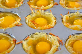 Cheesy Hash Brown Cups In Muffin Tin With Uncooked Egg In Center Of Each Hash Brown Cups Cheesy Hash Brown Cups Hash Brown Breakfast Cups