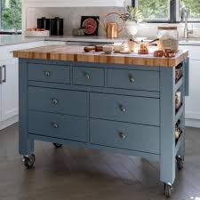 The cabinets are uniformly white, but what draws the eye is the glossy blue grey backsplash and butcher block island. Canadel Gourmet Customizable Kitchen Island With Butcher Block Top Wilson S Furniture Kitchen Islands