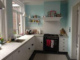 our new kitchen blue walls pip studio cups old tins terrazzo floor and work surface keuken inspiratie keuken terrazzo