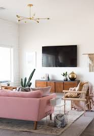 Living Room With Pink Couch And Natural Light Bright White Living Room Living Room Design Inspiration Apartment Living Room Minimalist Living Room