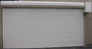 First, place the roller in the hinge. We Repair And Install Roll Up Garage Doors For Residential Homes And Also For Offices Garage Door Opener Installation Custom Garage Doors Garage Doors