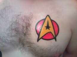 He also has plans for his left arm that involve. Red And Yellow Star Trek Insignia Tattoo On Chest For Men