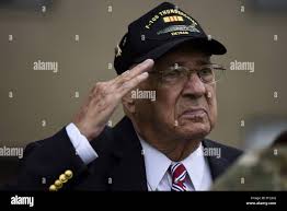 Retired Air Force Col. Murphy Neal Jones, Vietnam War veteran, salutes  during the national anthem at a POW/MIA retreat ceremony Sept. 21, 2018, at  Dover Air Force Base, Del. Jones spent more