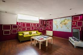 If your living room has had white or neutral colored walls for years, it might be time to add a little color to your walls. Contemporary Spacious Living Room With Wooden Floor Furnished With Bright Green Sofa And Decorated With Geometric Elements On Red Walls Inspiration Lounge Stock Photo 445595404