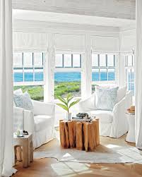 Simple White Clean Seating With Driftwood Tables In This Beach House Decor Coastal Living Rooms Beach House Interior Beach House Interior Design