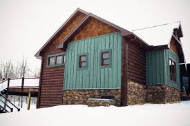 Exterior Board And Batten In A Green Stain Color Rustic Board And Batten Log Cabin Log Homes Stone Exterior Houses Log Cabin Exterior Cabin Exterior Colors