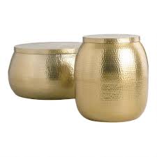 This accent table features a drum profile with visible hammered dimple patterns. Gold Hammered Metal Drum Cala Accent Table World Market