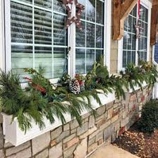 Pick a lighted garland with ornament accents. Winter Window Box Ideas