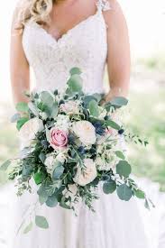 Flowers are one of the most important elements when planning a wedding, and the floral décor you choose can have a huge impact on the overall look and feel of your day. Eucalyptus Blue Thistle And Rose Bouquet Blue Wedding Bouquet Pink Rose Wedding Bouquet White Wedding Bouquets