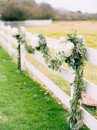 Rustic Fence Garland Accented With Hydrangea Clusters At Mission Ranch Fleurish Floral Designs Front Yard Fence Fence Plants Fence Landscaping