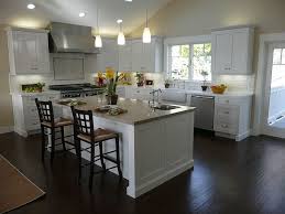 This gorgeous contemporary kitchen utilizes dark granite counter tops and wood flooring to break up the use of bright white. White Kitchen Cabinets Dark Wood Floors Novocom Top