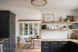 Remove upper cabinet doors to give a narrow kitchen a sense of openness. Kitchen Renovation With Dark Cabinets And Open Shelving Bigger Than The Three Of Us