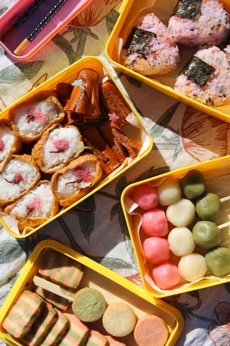 Hanami bento and dango sweets prepared for cherry blossom viewing picnics.
