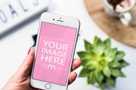 Mockup Template Featuring A Woman Holding A White Iphone In Hand On A Table Background Upload Your Own Image And Pro White Iphone Iphone Photoshop Mockup Free